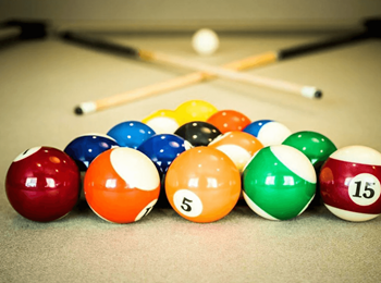 A set of pool balls with the number 5 and 15 visible.